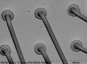 Scanning electron micrograph of ball bonds and wire stems preserved on the bond pads after decapsulation.