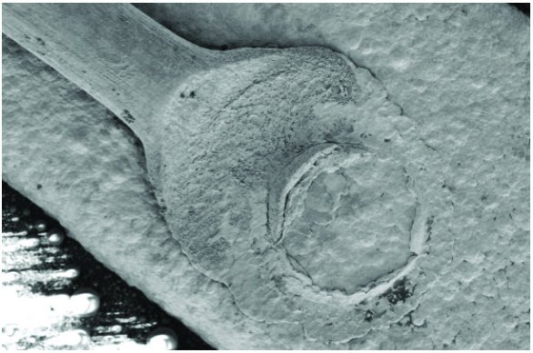 Close-up scanning electron micrograph of a preserved ball bond and wire stem on the bond pad.